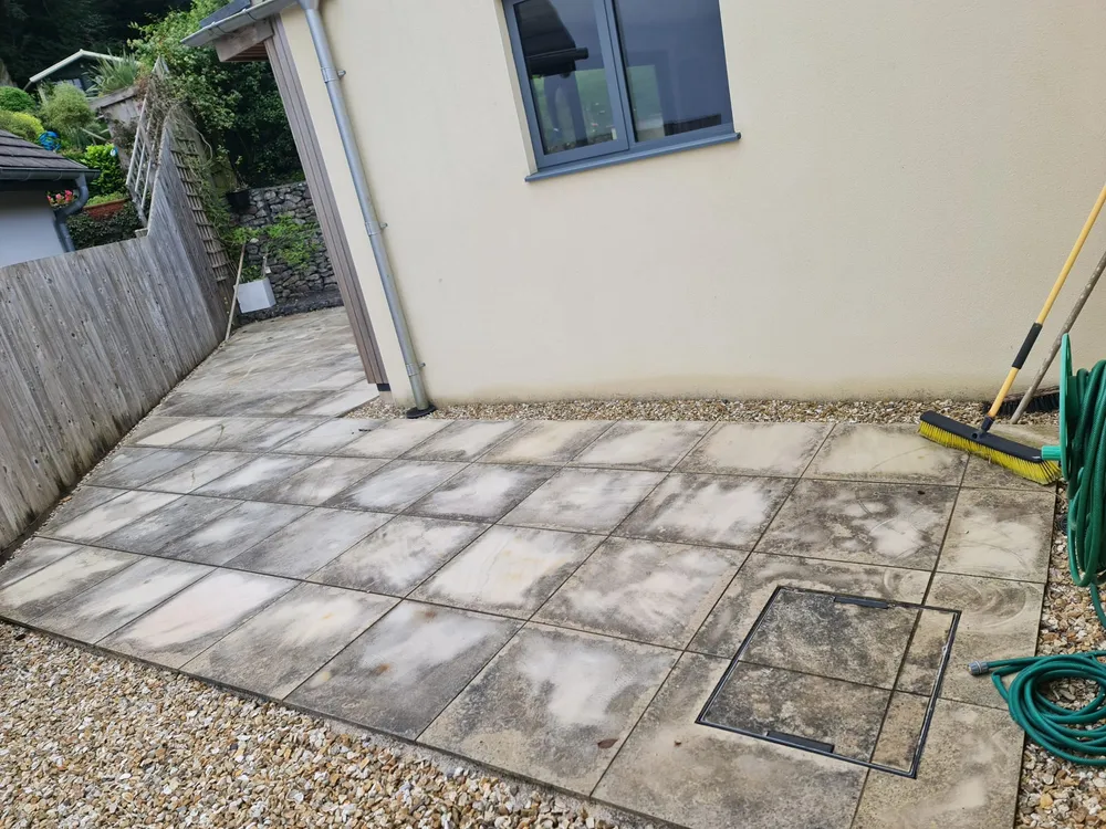 Patio slabs covered in algae before cleaning