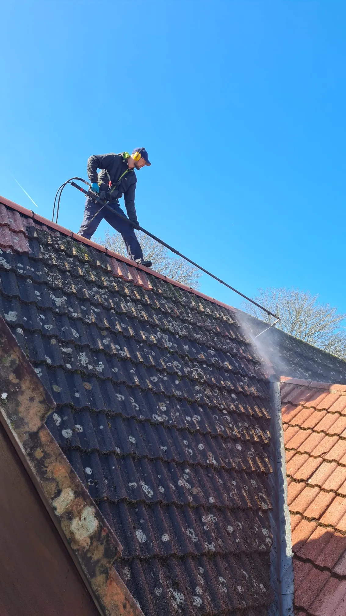 Robert cleaning roof tiles with specialist spinning brush equipment