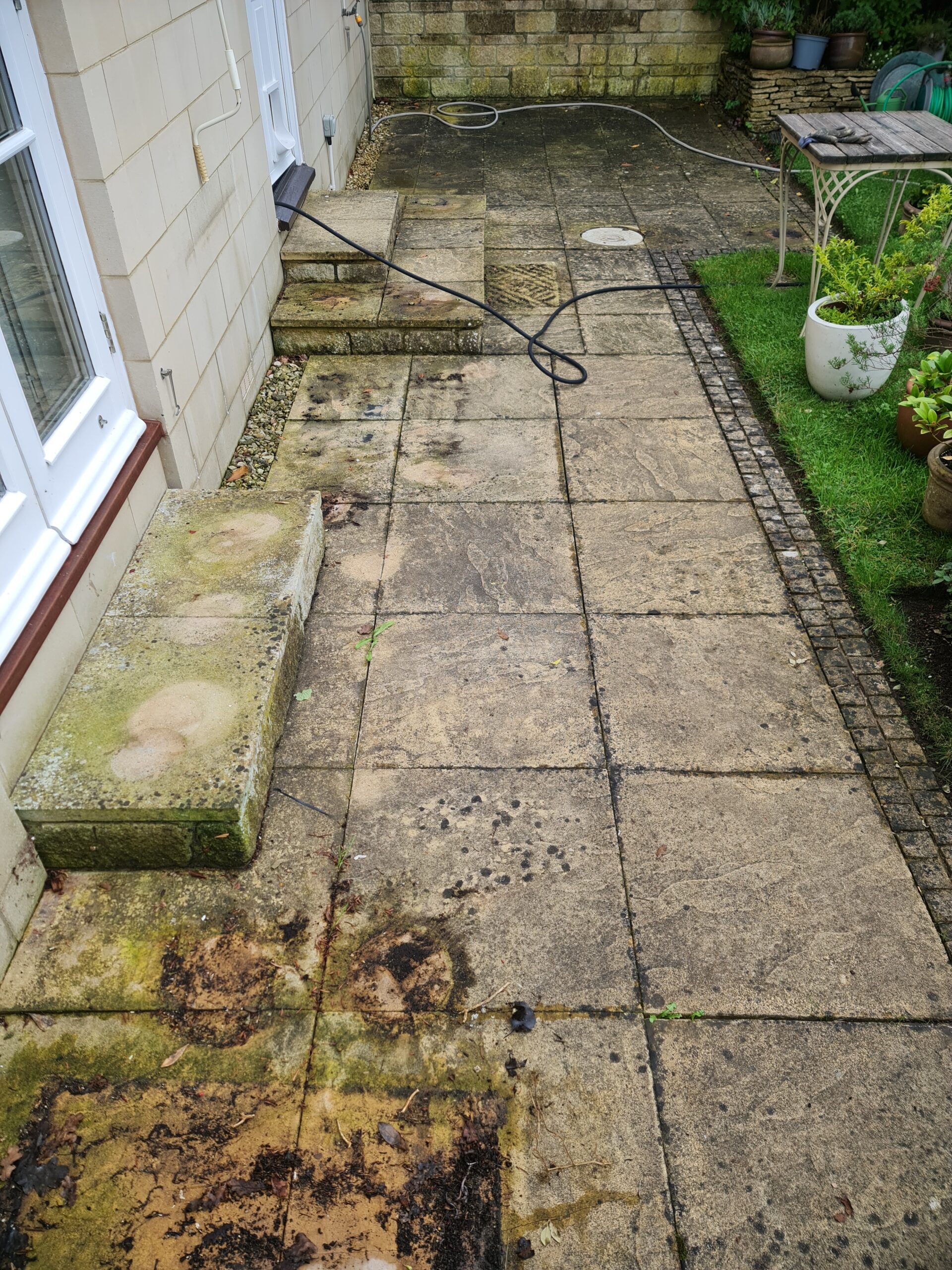 Patio before professional cleaning — algae and staining