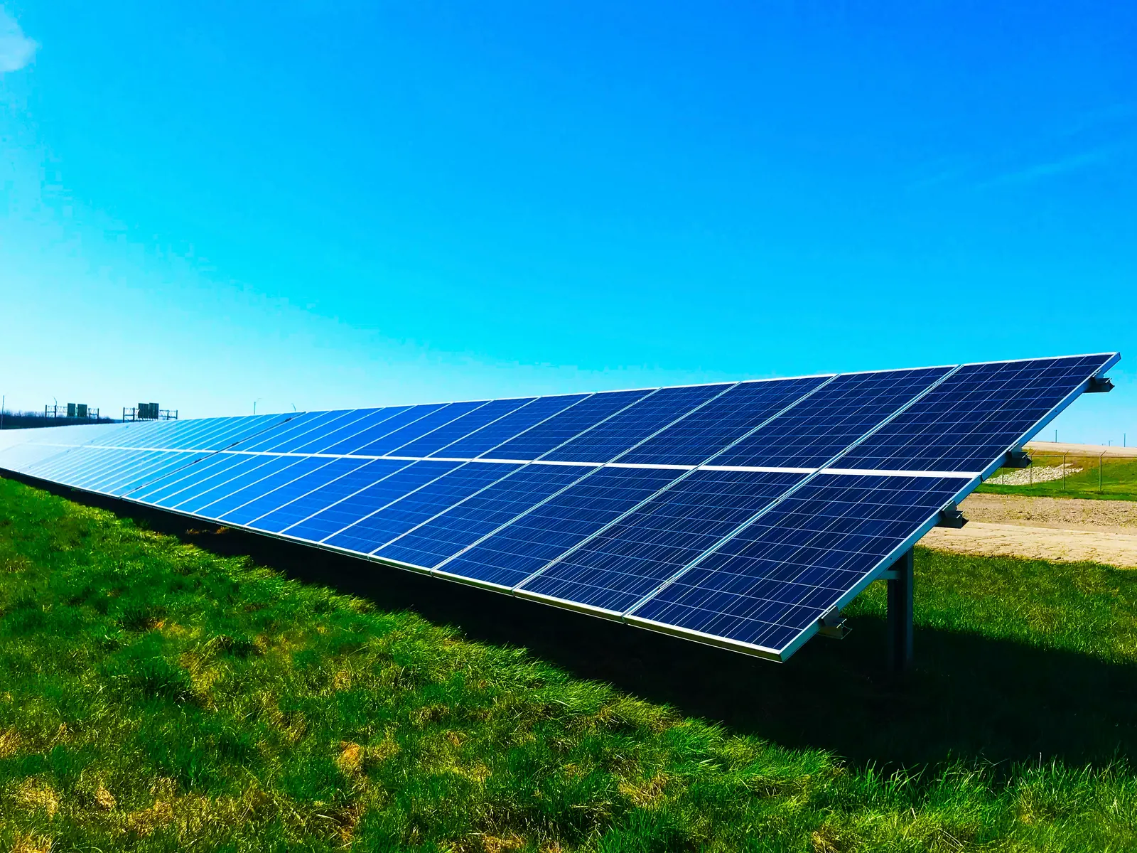 Rooftop-scale solar glass under a clear sky — the surfaces we clean on properties in Combe Down